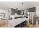 Modern kitchen with black cabinets, white countertops, stainless steel appliances, and decorative backsplash at 1588 W 111Th Ave, Northglenn, CO 80234