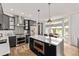 Modern kitchen with stainless steel appliances, a large island, and a dining area at 1588 W 111Th Ave, Northglenn, CO 80234