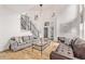 Open living room features hardwood floors, neutral paint, and access to the front door at 1588 W 111Th Ave, Northglenn, CO 80234