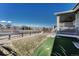 Spacious backyard with a well-maintained lawn, fenced perimeter, and covered patio at 2541 Leafdale Cir, Castle Rock, CO 80109