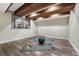 Finished basement area with exposed wood beams, workout equipment and luxury vinyl plank flooring at 2541 Leafdale Cir, Castle Rock, CO 80109