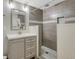 Modern bathroom featuring gray tiles, mosaic accents, and a sleek vanity with a gray cabinet at 2541 Leafdale Cir, Castle Rock, CO 80109