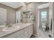 Bright bathroom features double vanity, framed mirror, and tile flooring for a clean and modern look at 2541 Leafdale Cir, Castle Rock, CO 80109
