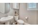 Charming half-bath with pedestal sink and oval mirror at 2541 Leafdale Cir, Castle Rock, CO 80109