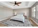 Bedroom showcasing ceiling fan and tray ceiling, hardwood floors, and natural light from several windows at 2541 Leafdale Cir, Castle Rock, CO 80109