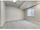 Carpeted bedroom with a large window and neutral color palette at 2541 Leafdale Cir, Castle Rock, CO 80109