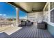 Inviting covered deck with comfortable seating, ceiling fan, and scenic backyard views at 2541 Leafdale Cir, Castle Rock, CO 80109