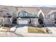 Two-story home featuring a two-car garage, front porch, and green siding at 2541 Leafdale Cir, Castle Rock, CO 80109