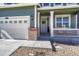 Close up of the exterior showcasing brick accents, white trim, and a welcoming front porch at 2541 Leafdale Cir, Castle Rock, CO 80109