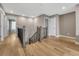 Spacious hallway with hardwood floors and a decorative staircase at 2541 Leafdale Cir, Castle Rock, CO 80109