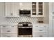A modern kitchen featuring stainless steel appliances and a decorative backsplash at 2541 Leafdale Cir, Castle Rock, CO 80109