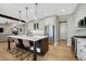 Stylish kitchen with island, stainless steel appliances, white cabinets, and hardwood floors at 2541 Leafdale Cir, Castle Rock, CO 80109