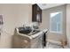 Well-equipped laundry room with modern washer and dryer, storage cabinet, and natural light at 2541 Leafdale Cir, Castle Rock, CO 80109