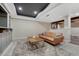 Finished basement living room with exposed wood beams and leather sofa at 2541 Leafdale Cir, Castle Rock, CO 80109