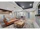 Finished basement living room with wood beams, wet bar and leather sofa at 2541 Leafdale Cir, Castle Rock, CO 80109