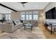Inviting living room featuring a large sectional sofa, hardwood floors, and bright windows at 2541 Leafdale Cir, Castle Rock, CO 80109