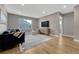 Comfortable living room featuring modern decor, a large window, and hardwood floors at 2541 Leafdale Cir, Castle Rock, CO 80109