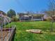 Spacious backyard with green lawn, garden beds, deck, and screened-in porch at 9045 E Floyd Ave, Denver, CO 80231
