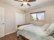 Comfortable bedroom with a window, closet, hardwood floors, and a ceiling fan at 9045 E Floyd Ave, Denver, CO 80231