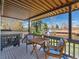 Relax on the covered deck with stylish seating and a view of the landscaped backyard and neighborhood at 9045 E Floyd Ave, Denver, CO 80231