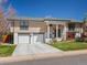 Charming home features a two car garage, lovely landscaping, and a quaint front entry at 9045 E Floyd Ave, Denver, CO 80231