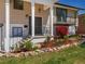 Inviting front entry with manicured landscaping, featuring stone accents and vibrant flowers at 9045 E Floyd Ave, Denver, CO 80231