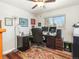 Functional home office with ample desk space, storage, and a comfortable executive chair at 9045 E Floyd Ave, Denver, CO 80231