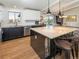 Bright kitchen features black and white cabinets, stainless steel appliances, and a large center island at 9045 E Floyd Ave, Denver, CO 80231