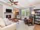 Cozy living room with a stone fireplace, modern decor, and French doors to the exterior at 9045 E Floyd Ave, Denver, CO 80231