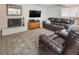 Inviting living room features a fireplace, flat screen TV, and comfortable leather seating at 9045 E Floyd Ave, Denver, CO 80231