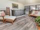 Comfortable sunroom has stylish chairs and a lounger near the stairway to the lower level at 9045 E Floyd Ave, Denver, CO 80231