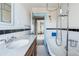 Bathroom with clawfoot tub and wood vanity at 1149 Steele St, Denver, CO 80206