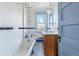 Bathroom with clawfoot tub and wood vanity at 1149 Steele St, Denver, CO 80206