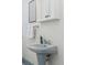 Simple bathroom with pedestal sink and mirrored medicine cabinet at 1149 Steele St, Denver, CO 80206