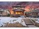 Brick two-story home with snow-covered lawn and steps leading to the entrance at 1149 Steele St, Denver, CO 80206