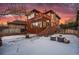 Back exterior view of a charming home with deck and snowy yard at 1149 Steele St, Denver, CO 80206