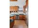 Updated kitchen with wood cabinets, stainless steel appliances, and island at 1149 Steele St, Denver, CO 80206