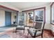 Cozy living room with two armchairs and access to a deck at 1149 Steele St, Denver, CO 80206