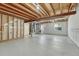 Unfinished basement with exposed beams, concrete floor, and laundry hookups, offering potential for customization at 5380 S Prescott St, Littleton, CO 80120