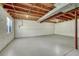 Spacious unfinished basement with concrete flooring and exposed ceiling, offering potential for customization and expansion at 5380 S Prescott St, Littleton, CO 80120