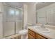 Bright bathroom with a modern vanity, toilet, and sliding glass door shower enclosure at 5380 S Prescott St, Littleton, CO 80120
