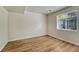 A bedroom featuring wood-look flooring, a window and neutral walls for versatile styling at 5380 S Prescott St, Littleton, CO 80120