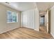 Bedroom featuring wood-look floors, a closet with sliding doors, and a window providing natural light at 5380 S Prescott St, Littleton, CO 80120