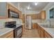 Well-equipped kitchen featuring white countertops, stainless steel appliances, and warm oak cabinets for storage at 5380 S Prescott St, Littleton, CO 80120
