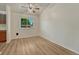 Bright living room with wood-look floors and a window providing ample natural light at 5380 S Prescott St, Littleton, CO 80120