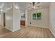 Bright living area with wood-look floors, a window, and neutral-colored walls providing a blank canvas at 5380 S Prescott St, Littleton, CO 80120