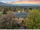 Aerial view of the home featuring solar panels, lush landscaping, and mountain views at 1069 Crestmoor Dr, Boulder, CO 80303