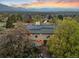 Aerial view of updated home featuring solar panels, mature trees, and landscaping at 1069 Crestmoor Dr, Boulder, CO 80303