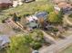 Aerial view of a home with a large manicured garden, long driveway, and a charming detached garage at 1069 Crestmoor Dr, Boulder, CO 80303