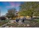 Inviting backyard patio with mature trees, outdoor seating, and lush landscaping, ideal for relaxation and entertainment at 1069 Crestmoor Dr, Boulder, CO 80303